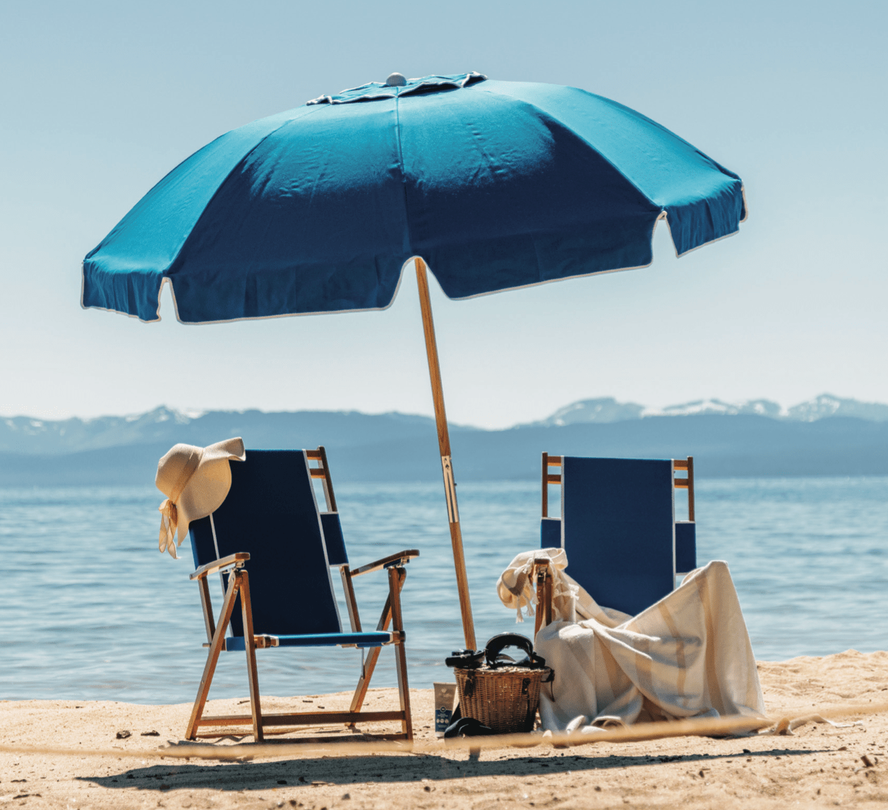 Screenshot 2024-06-09 at 7.00.35 PM a couple of lawn chairs sitting on top of a sandy beach